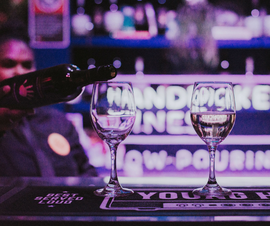 Wine pouring in glass at bar